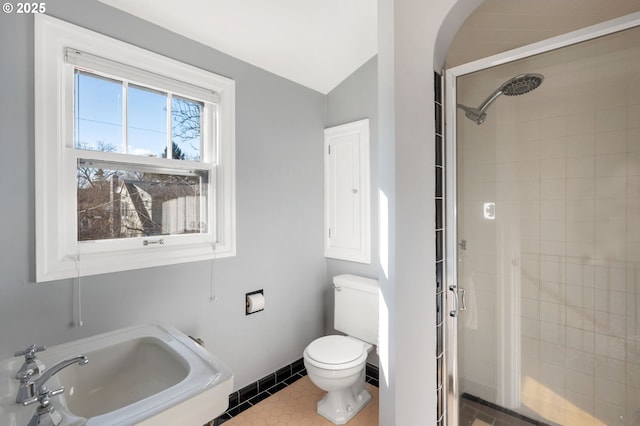 full bathroom featuring tile patterned floors, a sink, toilet, and a shower stall