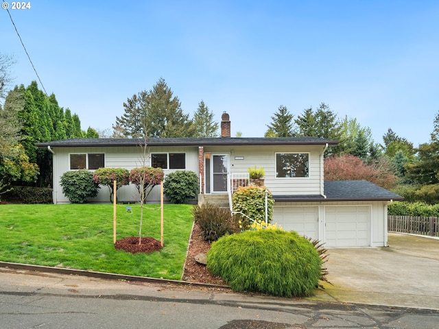 single story home with a garage, fence, concrete driveway, a chimney, and a front yard