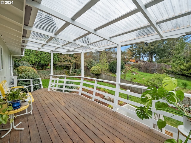 wooden terrace with a fenced backyard and a pergola