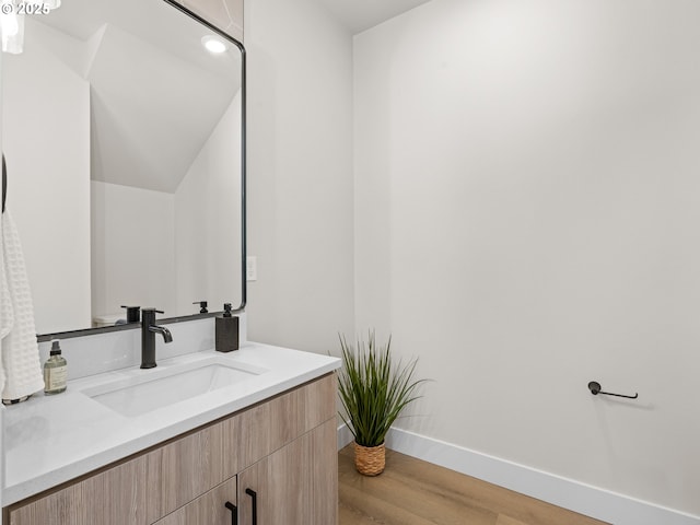 1562 NE 52nd Ave, Portland, OR 97213 - bathroom with vanity, wood finished floors, and baseboards