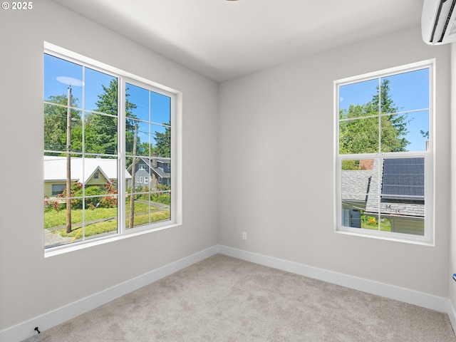 1562 NE 52nd Ave, Portland, OR 97213 - spare room featuring an AC wall unit, plenty of natural light, and baseboards