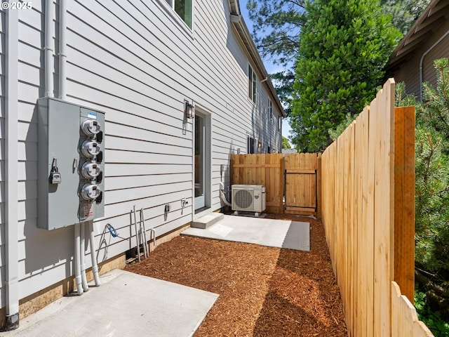 1562 NE 52nd Ave, Portland, OR 97213 - view of home's exterior featuring a cooling unit, a gate, and a patio area
