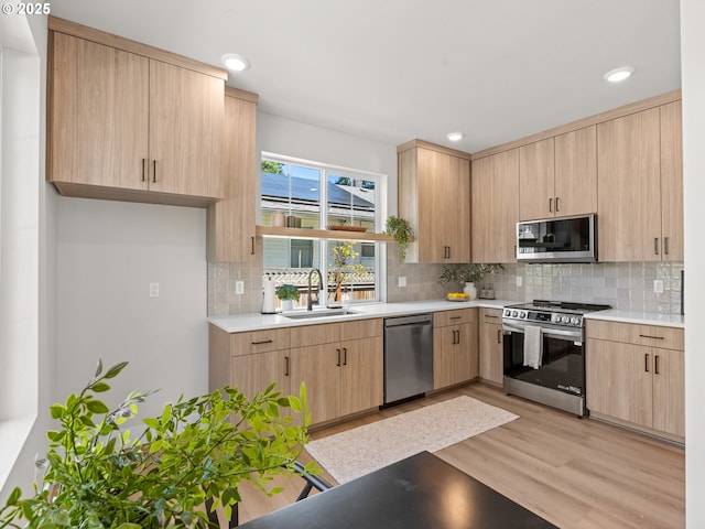 1562 NE 52nd Ave, Portland, OR 97213 - kitchen featuring a sink, stainless steel appliances, light brown cabinets, light countertops, and recessed lighting