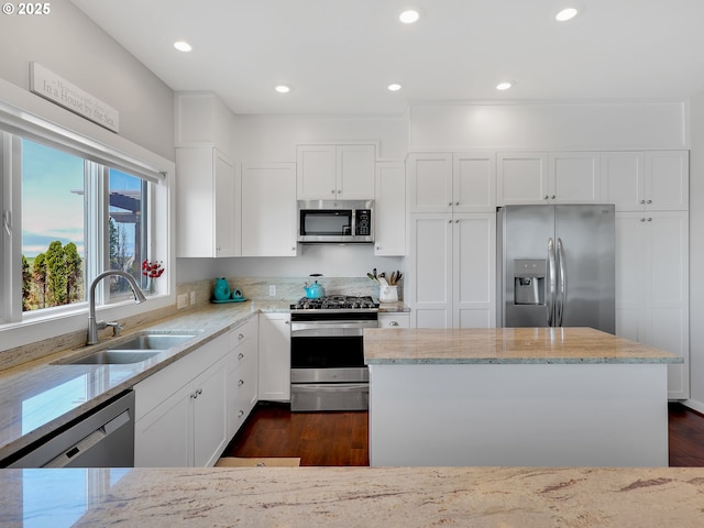 4580 Fairway Ave, Gearhart, OR 97138 - kitchen with stainless steel appliances, a sink, light stone countertops, white cabinets, and recessed lighting