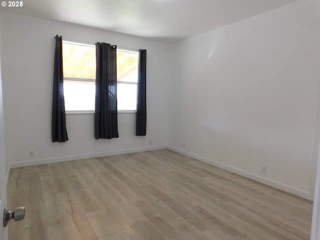 spare room featuring light wood-type flooring