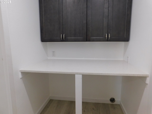 laundry room with cabinets and hardwood / wood-style floors