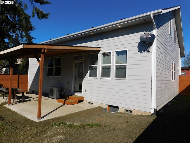 back of house with ac unit and a patio area