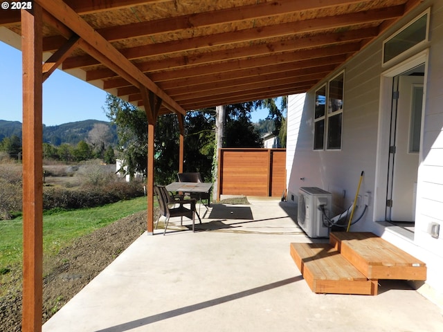 view of patio featuring a mountain view and ac unit