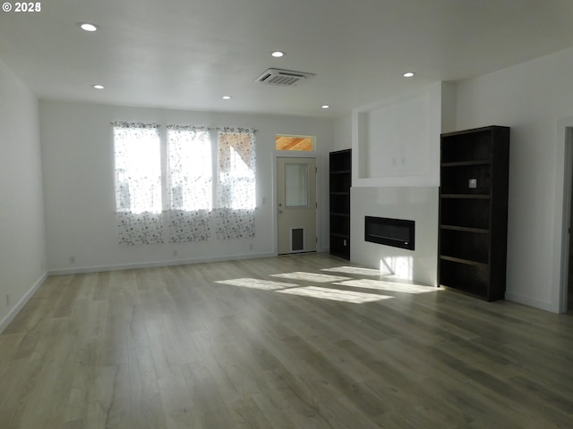 unfurnished living room with light wood-type flooring