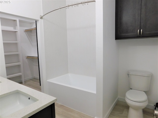 bathroom featuring vanity, hardwood / wood-style floors, and toilet