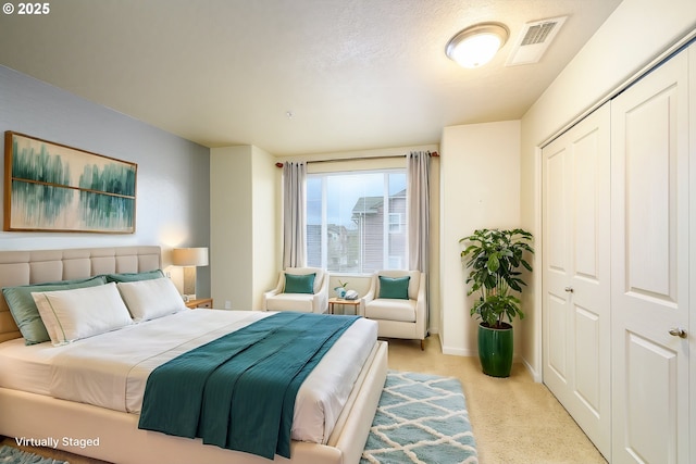 carpeted bedroom featuring a closet