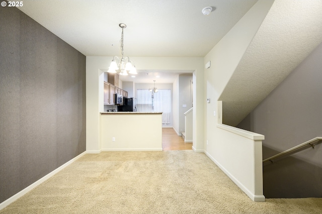 interior space with light carpet and an inviting chandelier