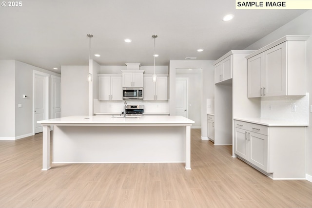 8909 S 3rd St Unit 30, Ridgefield, WA 98642 - kitchen featuring stainless steel appliances, recessed lighting, light wood-style flooring, and baseboards