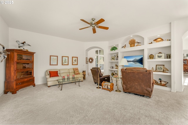 558 Wulff Ln, Roseburg, OR 97471 - living room with arched walkways, carpet floors, ceiling fan, and built in features
