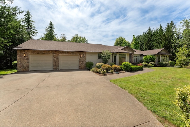 558 Wulff Ln, Roseburg, OR 97471 - ranch-style home featuring concrete driveway, a garage, a front lawn, and stone siding