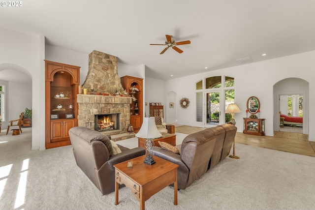 558 Wulff Ln, Roseburg, OR 97471 - living room featuring arched walkways, a ceiling fan, light colored carpet, a stone fireplace, and recessed lighting
