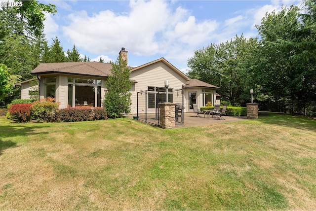 558 Wulff Ln, Roseburg, OR 97471 - back of property featuring a patio, a chimney, and a lawn