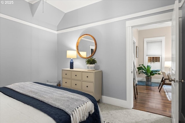 bedroom featuring carpet and lofted ceiling