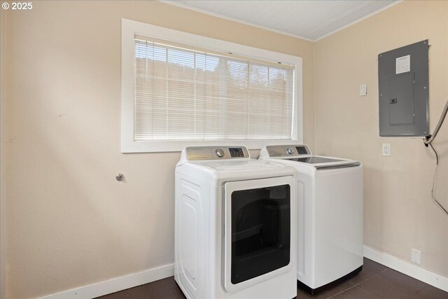 washroom featuring dark tile patterned floors, washer and clothes dryer, and electric panel