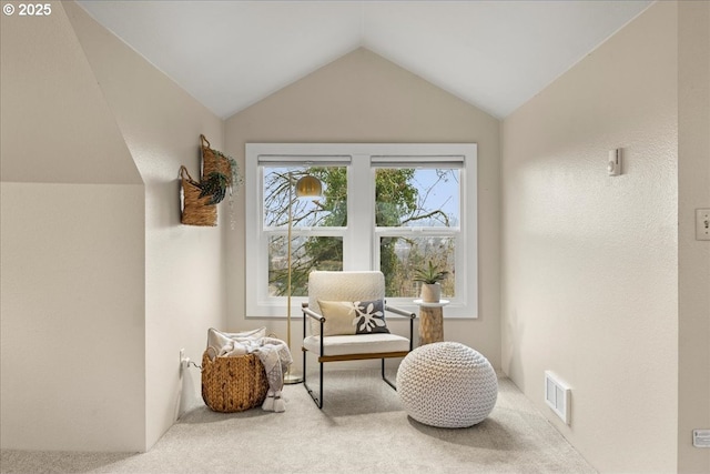 living area with vaulted ceiling and carpet floors