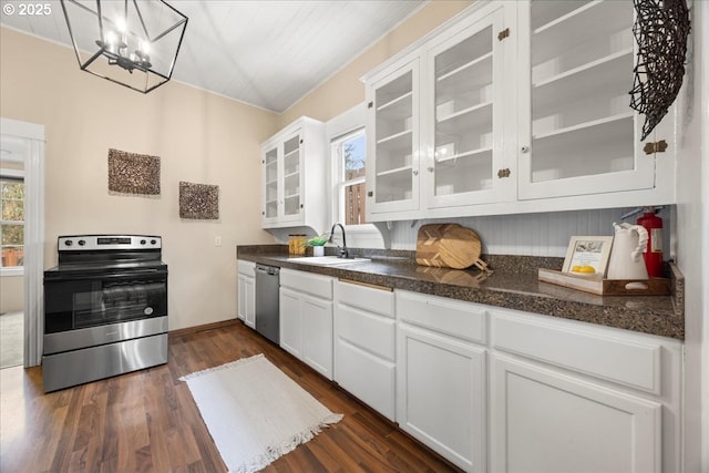 kitchen featuring stainless steel appliances, decorative light fixtures, dark hardwood / wood-style flooring, white cabinets, and sink