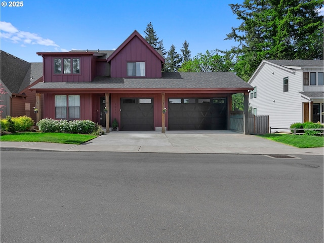 view of front of property featuring board and batten siding, concrete driveway, a garage, fence, and roof with shingles