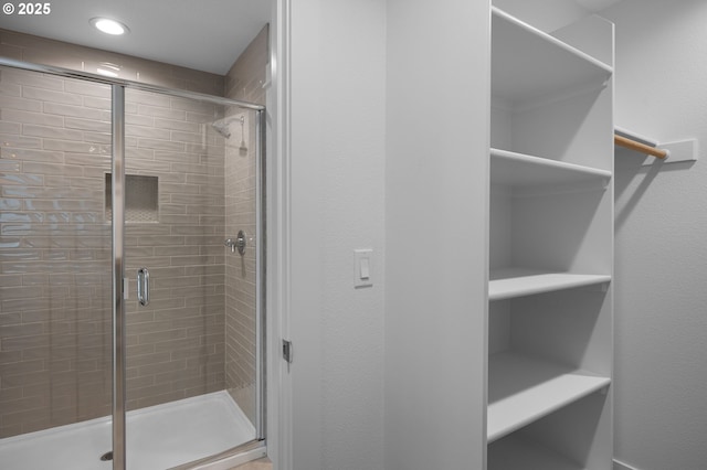 bathroom with recessed lighting and a stall shower