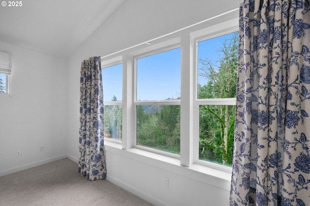 unfurnished room featuring lofted ceiling, carpet flooring, and baseboards