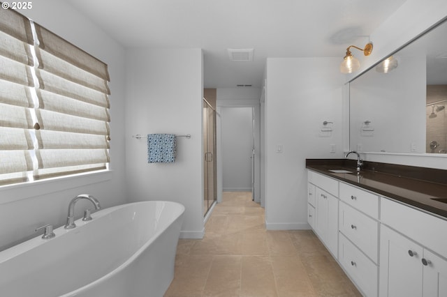 full bath with plenty of natural light, vanity, a shower stall, and tile patterned flooring