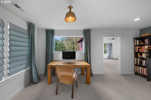 office area with plenty of natural light, baseboards, visible vents, and carpet floors