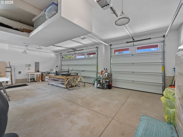 garage with electric panel and a garage door opener
