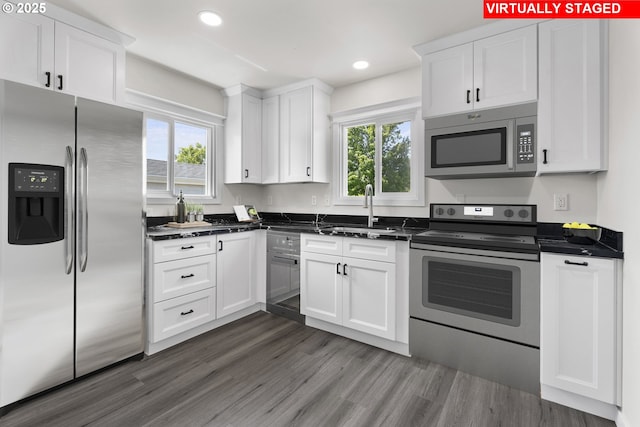 502 Williams Ave, Tillamook, OR 97141 - kitchen with appliances with stainless steel finishes, a sink, white cabinetry, recessed lighting, and dark wood-style flooring