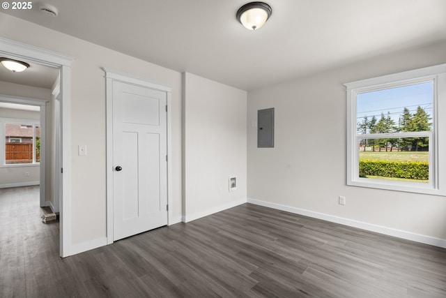 502 Williams Ave, Tillamook, OR 97141 - unfurnished bedroom featuring electric panel, dark wood-style flooring, and baseboards