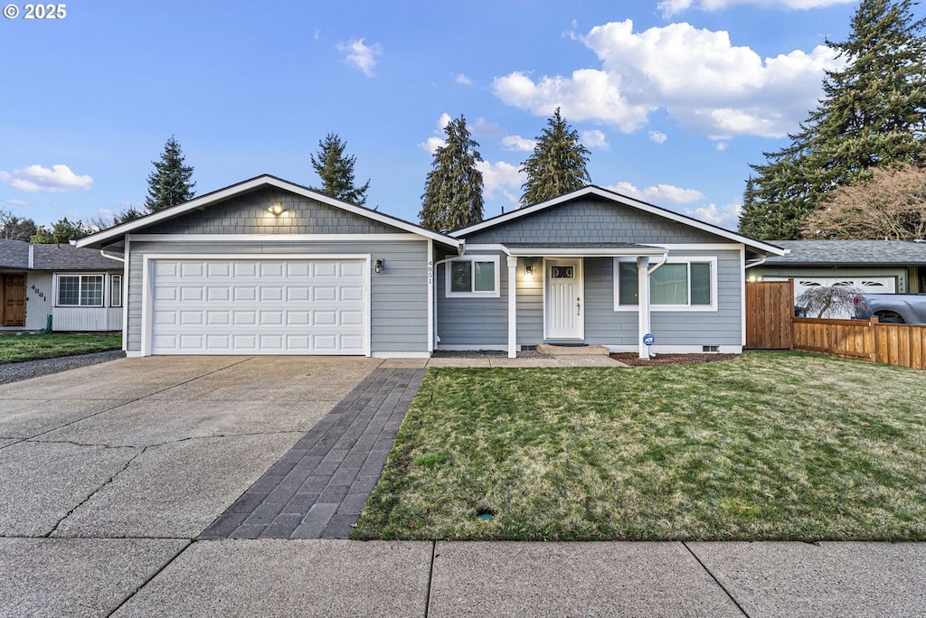 ranch-style home featuring a garage and a front lawn