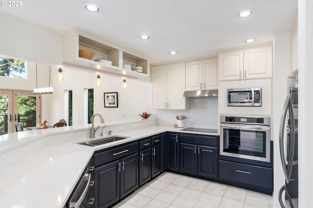 kitchen featuring under cabinet range hood, light tile patterned floors, french doors, stainless steel appliances, and a sink