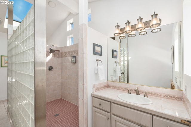 full bath with vanity, lofted ceiling with beams, and a walk in shower