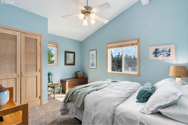 bedroom with a closet, ceiling fan, carpet flooring, and vaulted ceiling