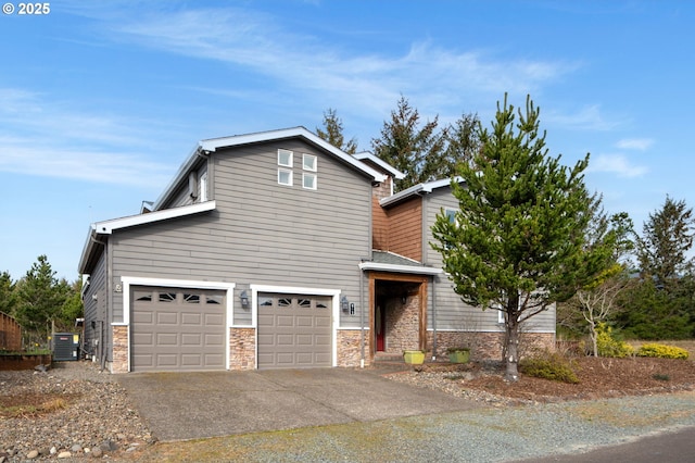 view of front facade featuring an attached garage, central AC unit, stone siding, and driveway