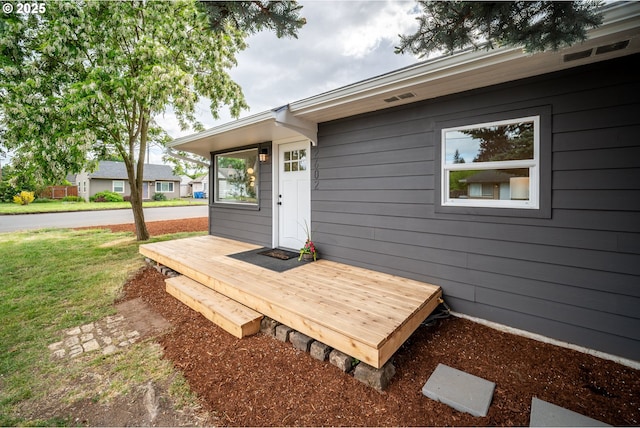 wooden deck featuring a lawn
