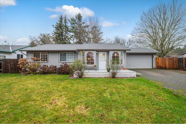 ranch-style home featuring a garage and a front lawn