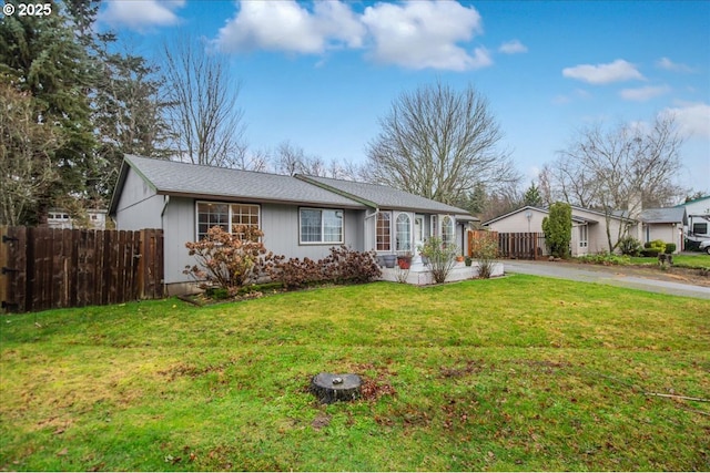 ranch-style home featuring a front yard