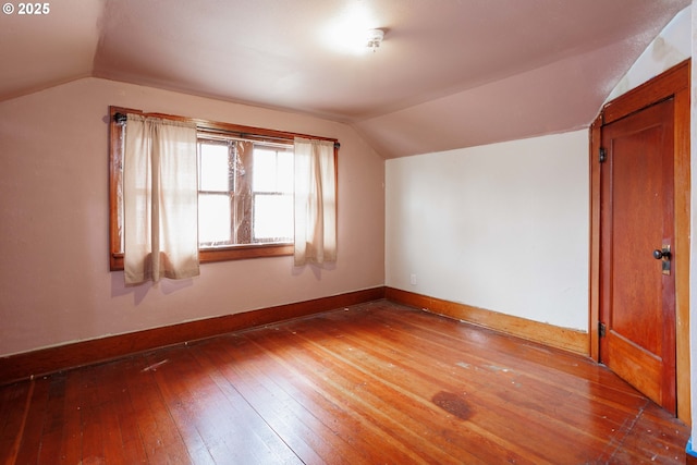 bonus room featuring baseboards, wood-type flooring, and lofted ceiling