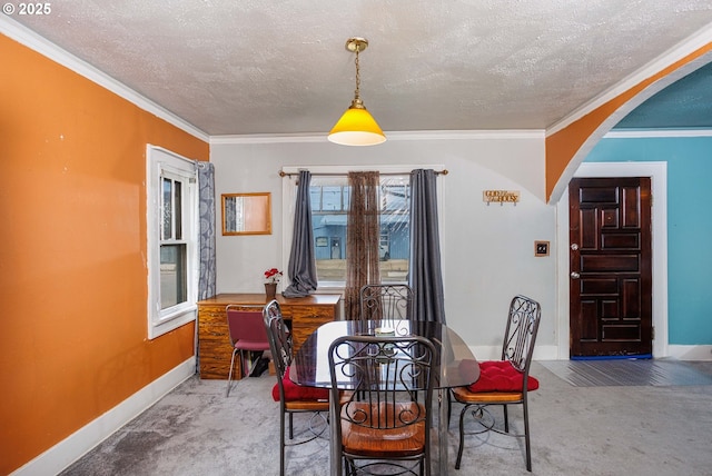 dining area featuring crown molding, baseboards, carpet, arched walkways, and a textured ceiling