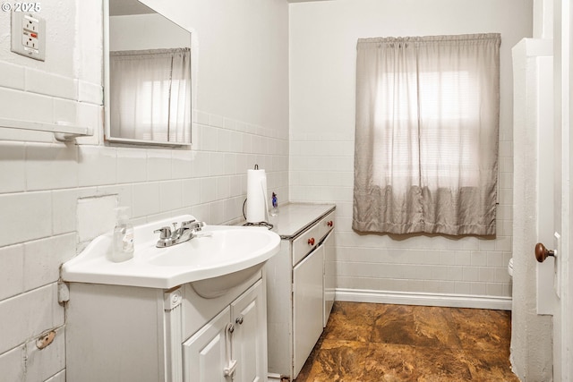 bathroom featuring vanity and tile walls