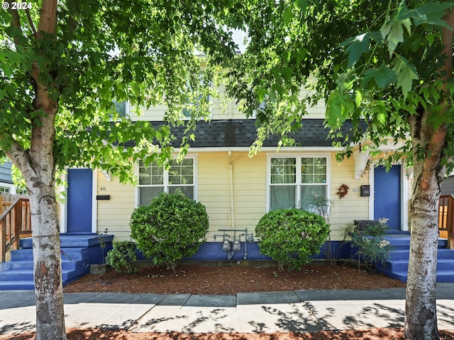 view of front of home featuring roof with shingles