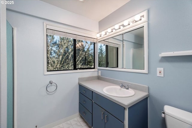 bathroom featuring vanity and toilet