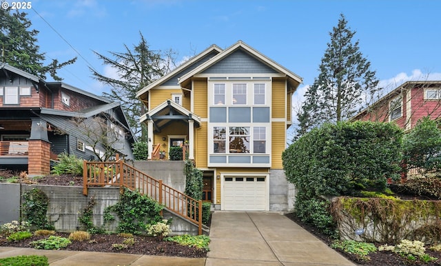 view of front of home with stairway, an attached garage, and driveway