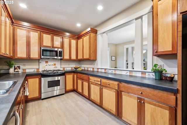 kitchen with dark countertops, recessed lighting, and appliances with stainless steel finishes