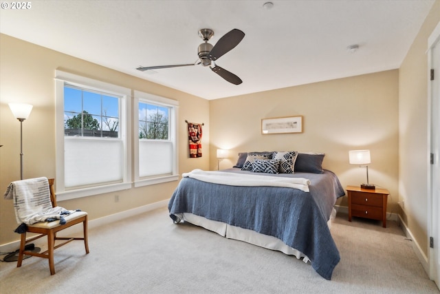 carpeted bedroom featuring a ceiling fan and baseboards