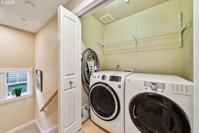 laundry area featuring washer and clothes dryer, laundry area, baseboards, and visible vents